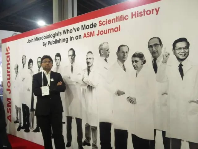 Tankeshwar Acharya in the stall of ASM Journal - Joining with Microbiologists who’ve made scientific history by publishing in an ASM Journal